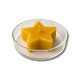 Blossom & Hive Beeswax star-shaped tealight in a clear glass dish on a white background