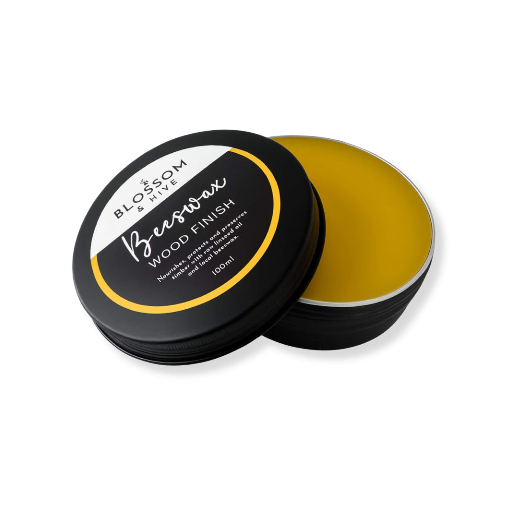 Blossom and Hive Beeswax wood finish in a black container with a white label on a white background