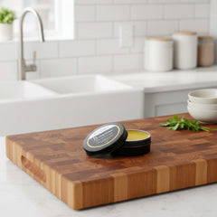 Blossom and Hive Beeswax Wood finish on a wooden cutting board in a kitchen.