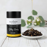 Blossom & Hive Sticky Honey Chai packaging with a bowl of chai on a wooden surface.