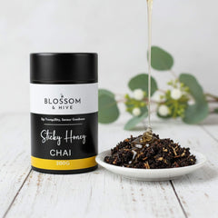 Blossom & Hive Sticky Honey Chai packaging with a bowl of chai on a wooden surface.