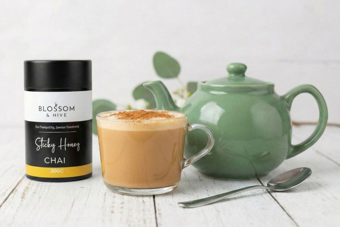 Blossom and Hive Sticky chai with a green ceramic teapot and a glass cup filled with chai and a spoon