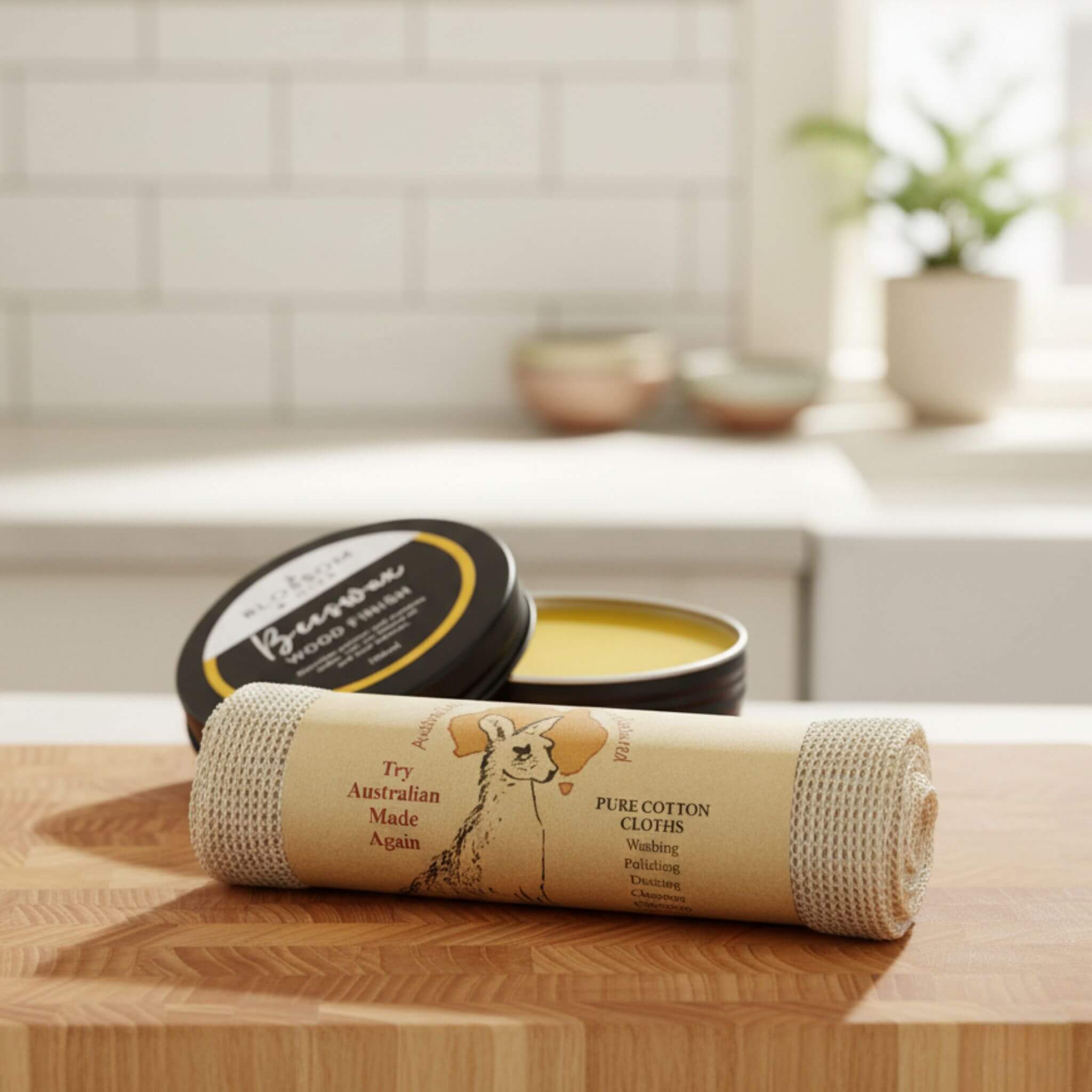 Wooden cutting board with a container of beeswax wood finish and a cotton cloth on a kitchen counter.
