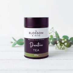 Tea canister labeled 'Blossom & Hive Daintree Tea' on a white background with green leaves.