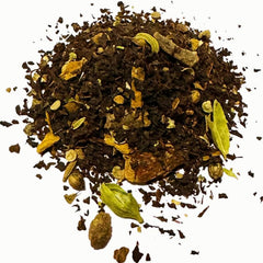 A close-up of Collombatti Naturals Masala Chai loose-leaf tea, showcasing a blend of Australian black tea with whole spices, including green cardamom pods, cinnamon bark, cloves, and cracked black pepper, against a white background